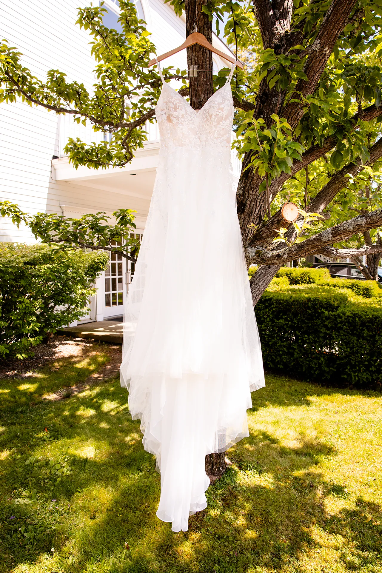 An ivory wedding dress hands from a tree at the Bar Harbor Inn and Spa in Bar Harbor, Maine.
