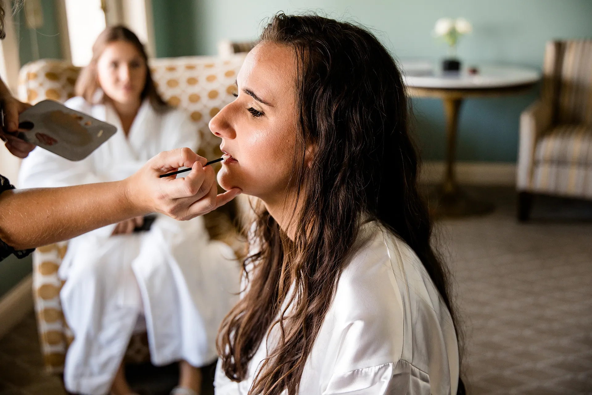 A bride gets her makeup done as she gets ready for a wedding at the Bar Harbor Inn and Spa in Bar Harbor, Maine.