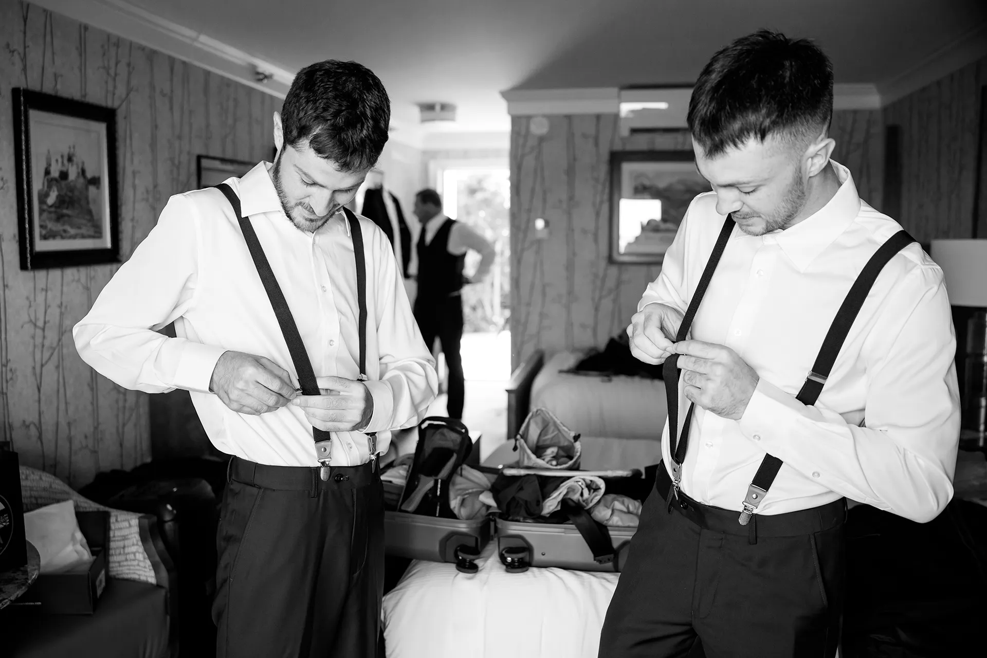 Groomsmen put on suspenders as they get ready for a wedding at the Bar Harbor Inn and Spa in Bar Harbor, Maine.