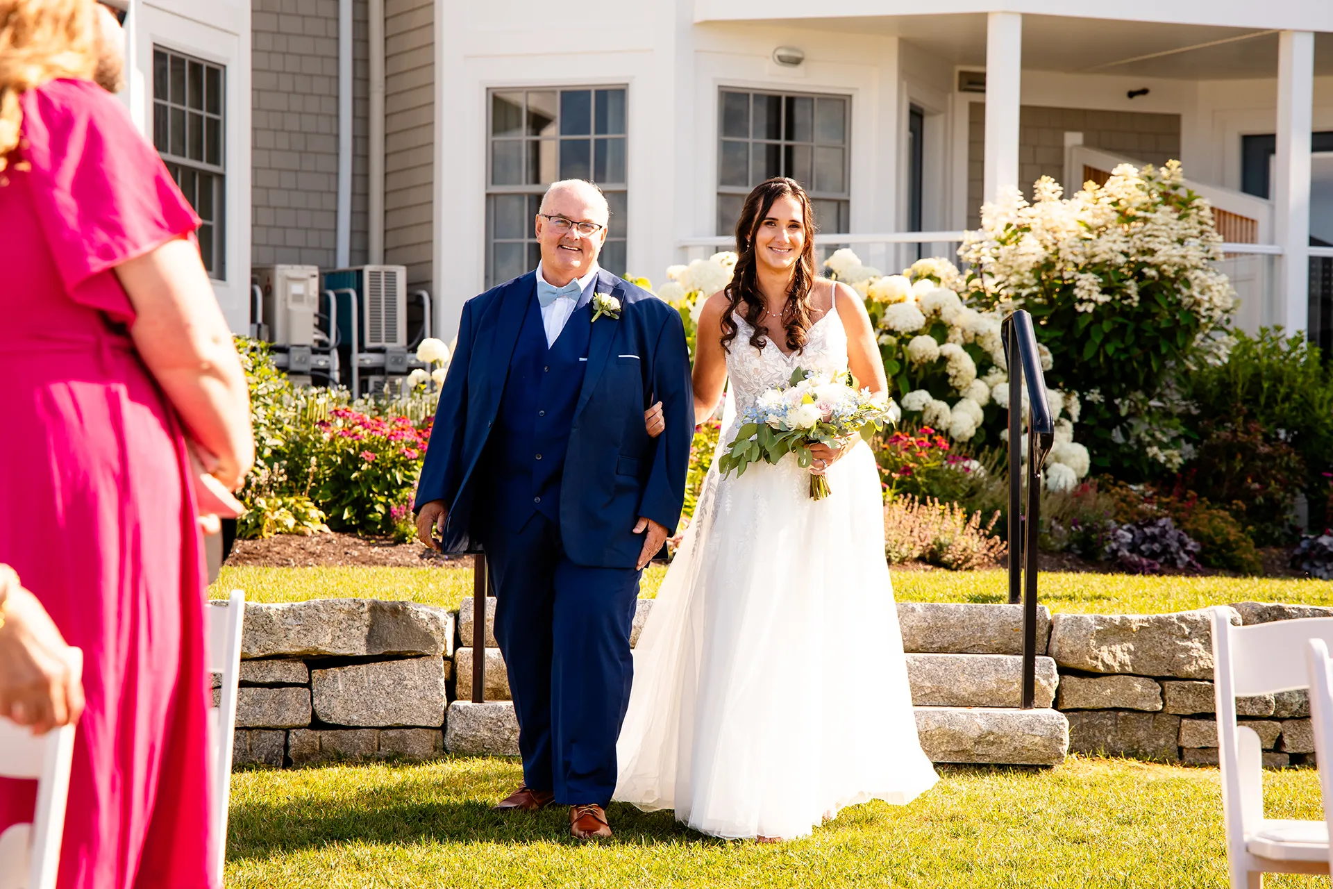 A bride and her dad walk down the aisle during a wedding ceremony at the Bar Harbor Inn and Spa in Bar Harbor, Maine.