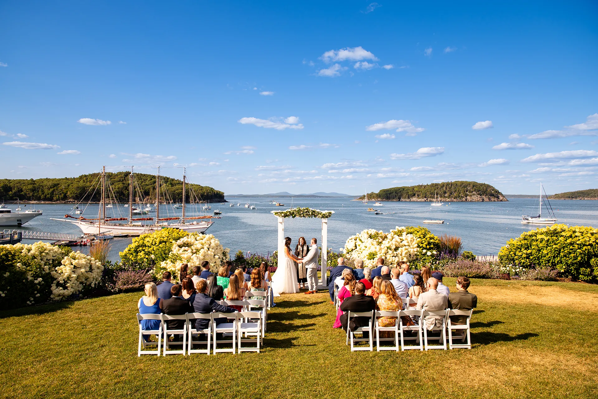 A wedding ceremony on the lawn of the Bar Harbor Inn and Spa overlooking Frenchman Bay in Bar Harbor, Maine.
