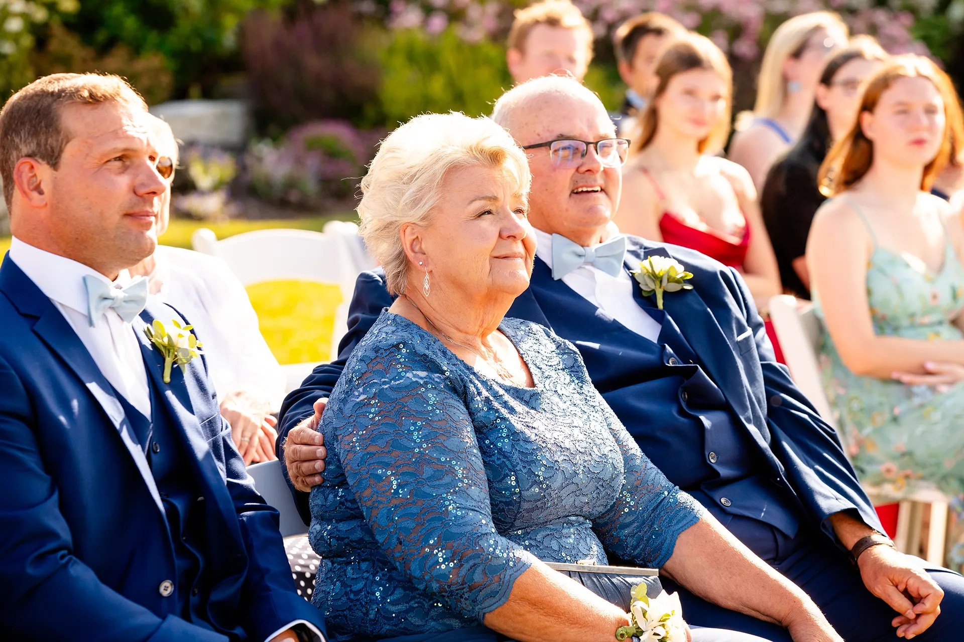 A mom and dad smile as they watch a wedding ceremony at the Bar Harbor Inn and Spa in Bar Harbor, Maine.