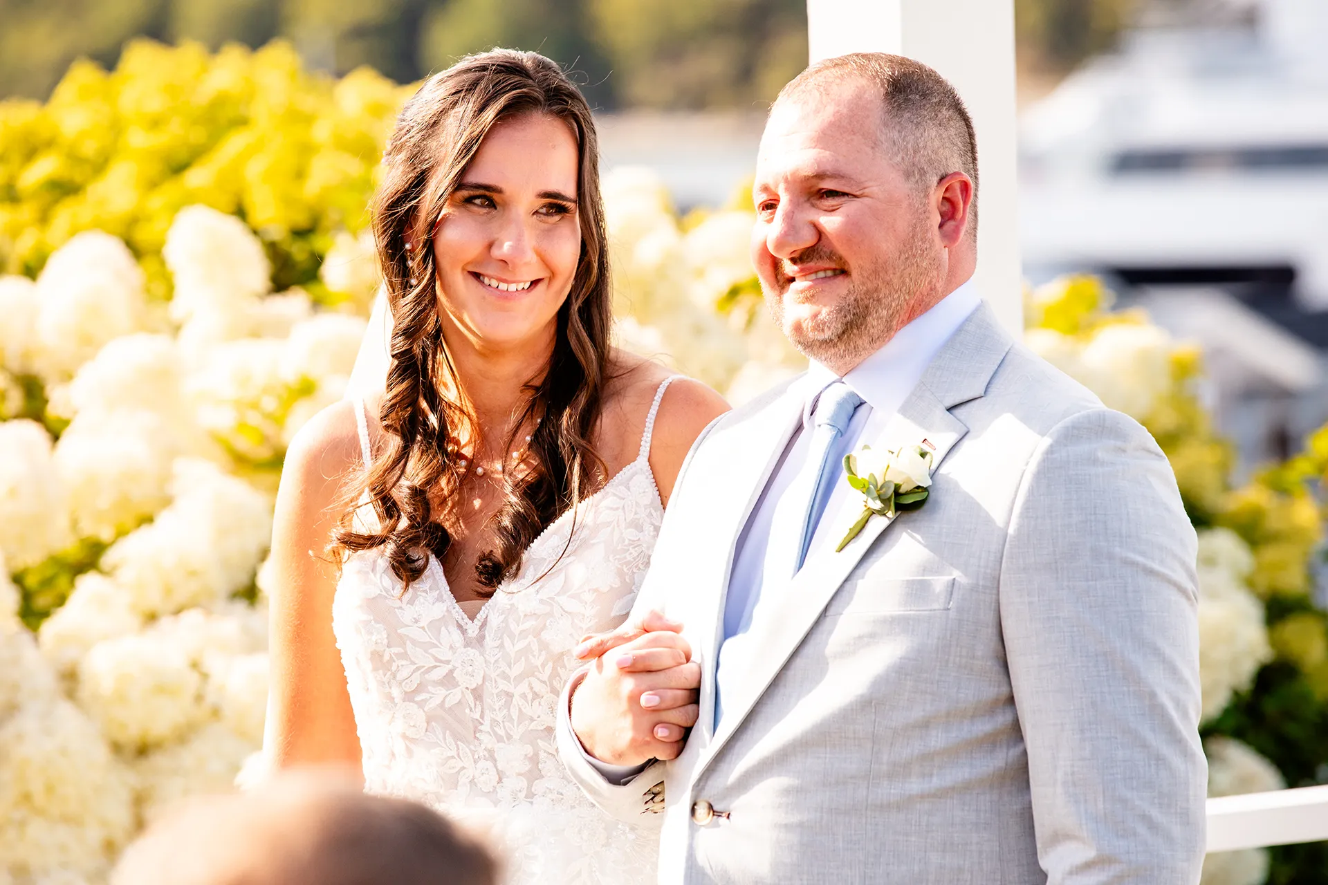 A bride smiles at a groom during a wedding ceremony at the Bar Harbor Inn and Spa in Bar Harbor, Maine.