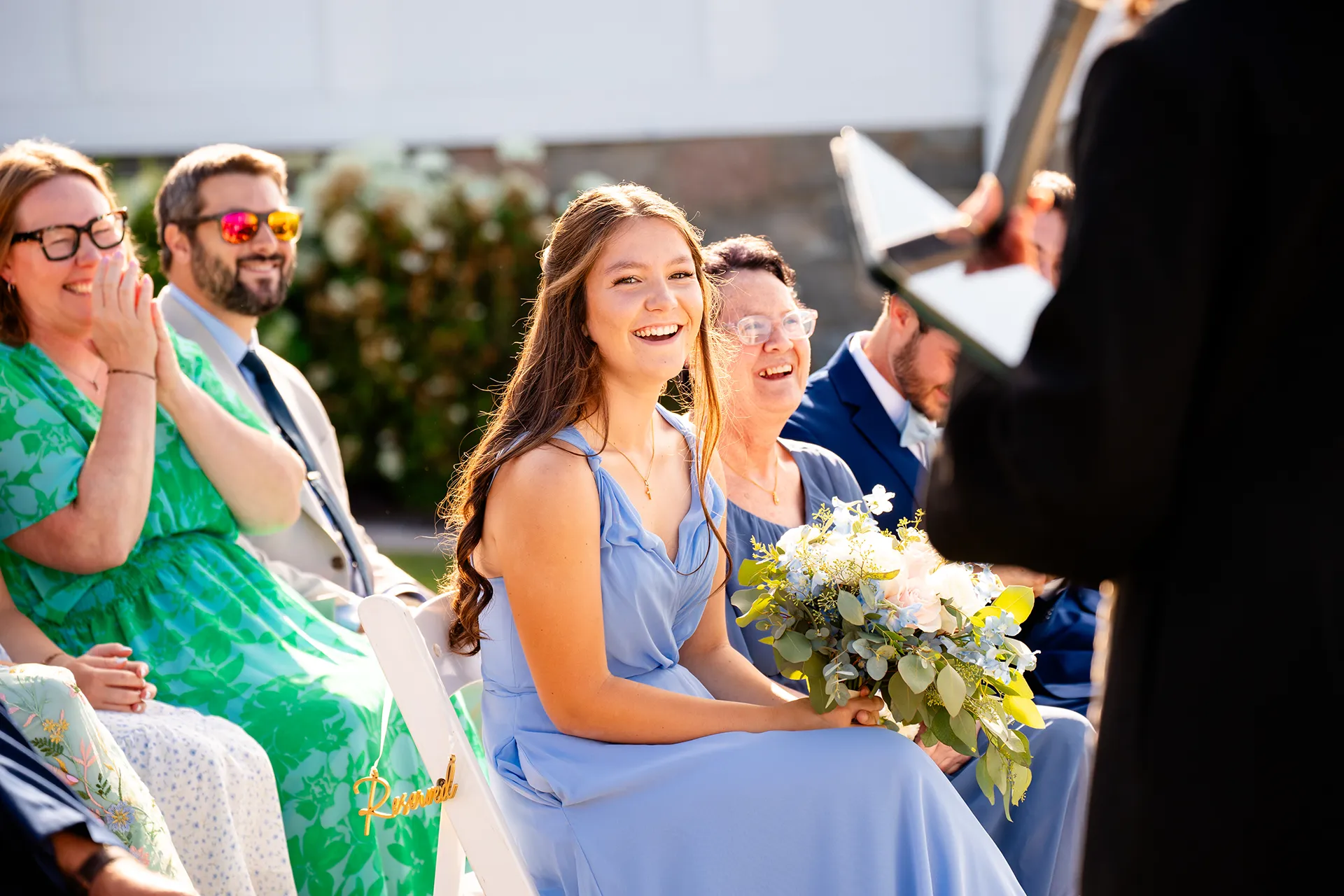 Wedding guests laugh as they listen to a wedding ceremony at the Bar Harbor Inn and Spa in Bar Harbor, Maine.