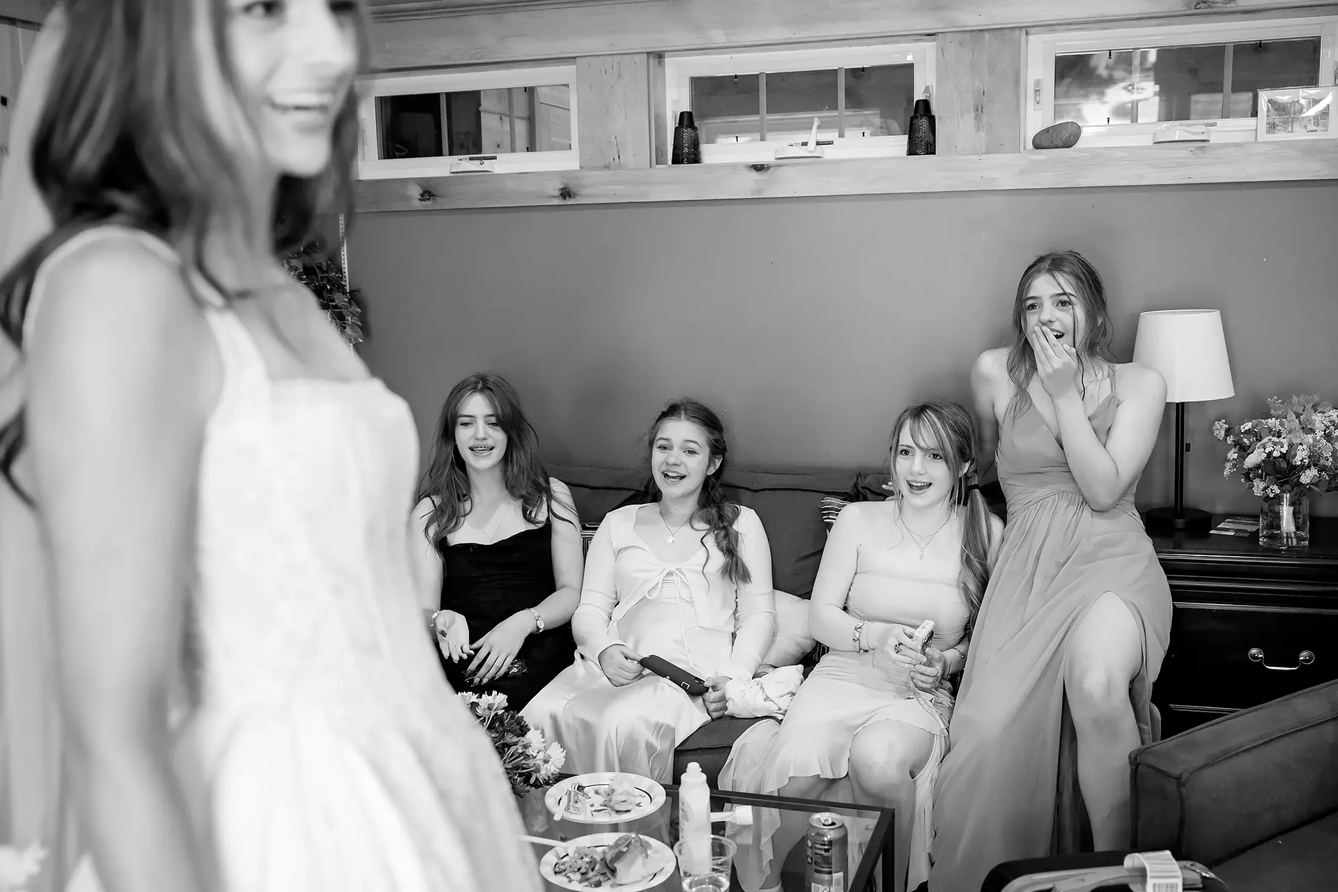 Bridesmaids are excited to see a bride at the Kingsley Pines Camp In Raymond, Maine.