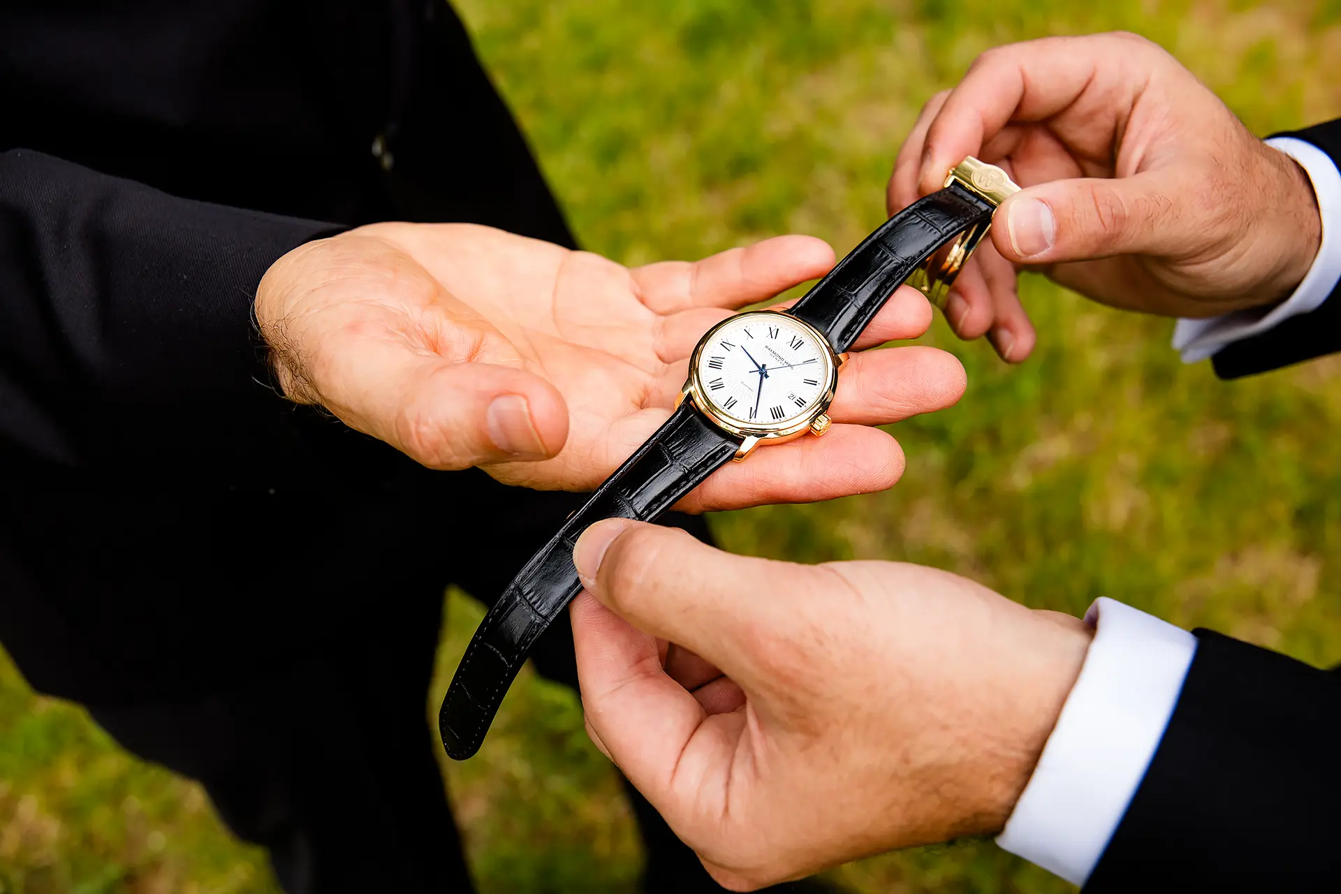 A closeup of a two hands holding a watch at Kingsley Pines Camp in Raymond, Maine.