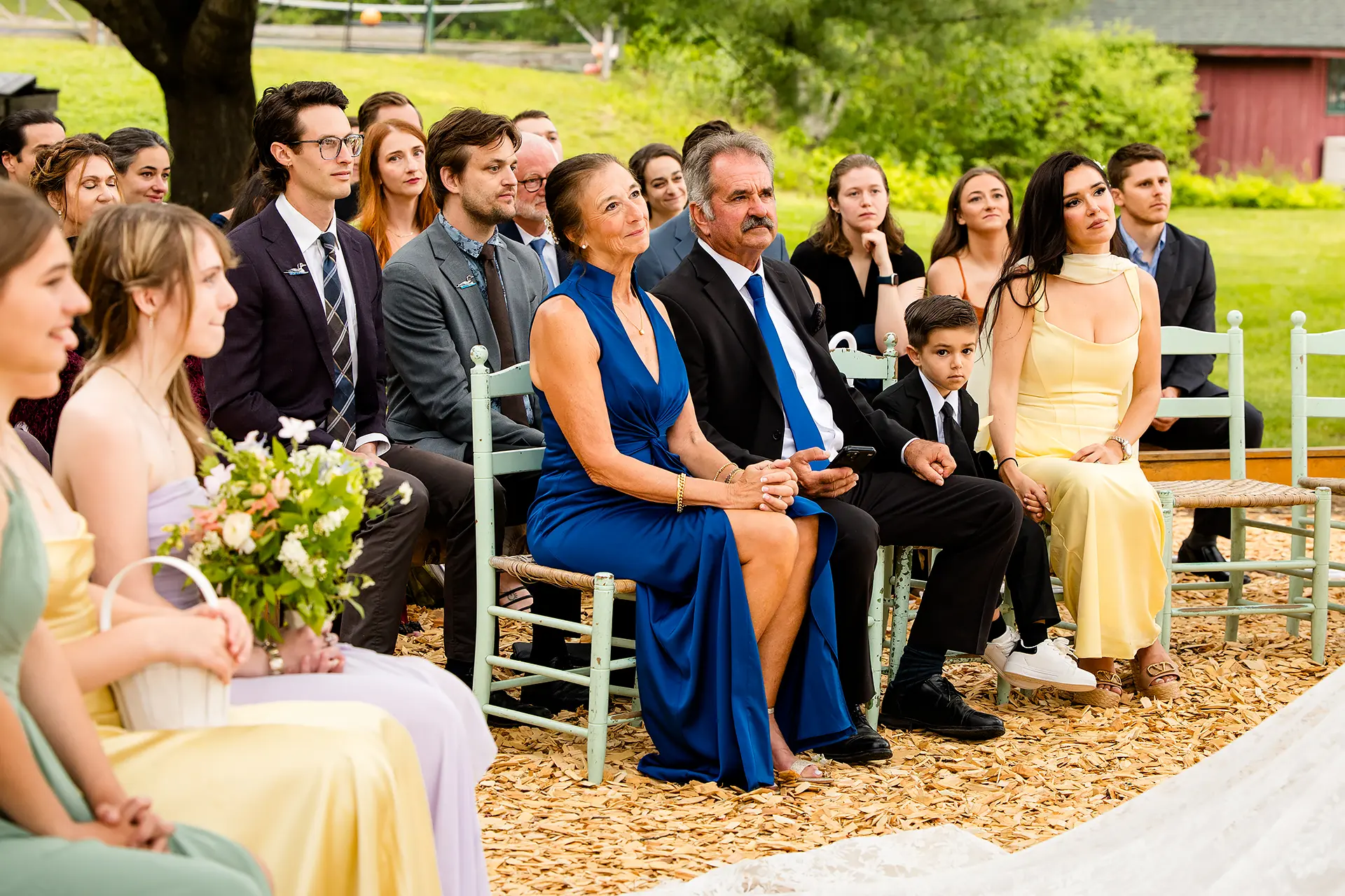 Wedding guests watch a bride and groom get marred during a ceremony at Kingsley Pines Camp in Raymond, Maine.