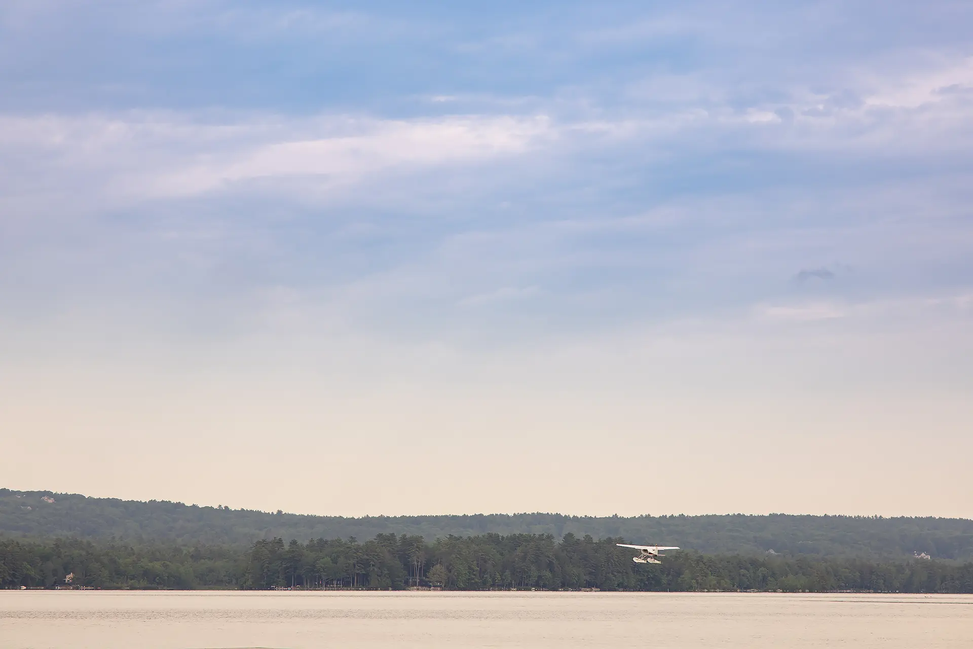 A lake plane takes off at Kingsley Pines Camp in Raymond, Maine.