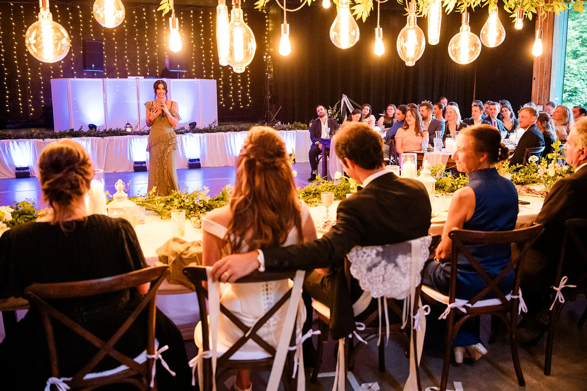 A bridesmaid gives a toast during a wedding reception at Kingsley Pines Camp in Raymond, Maine.