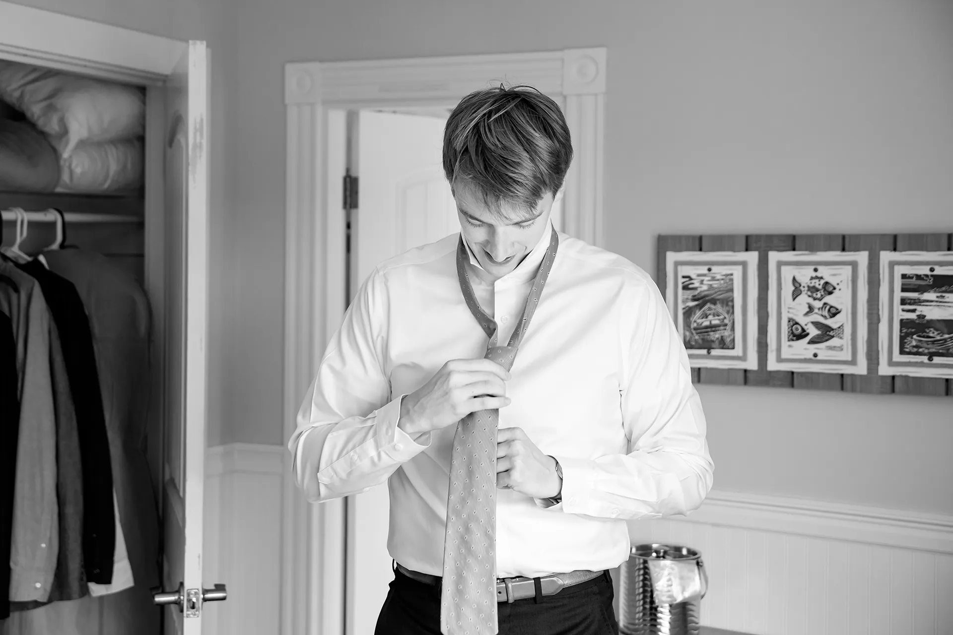 A groom puts on his tie as he gets ready for a wedding at the Nonantum Resort in Kennebunkport, Maine.