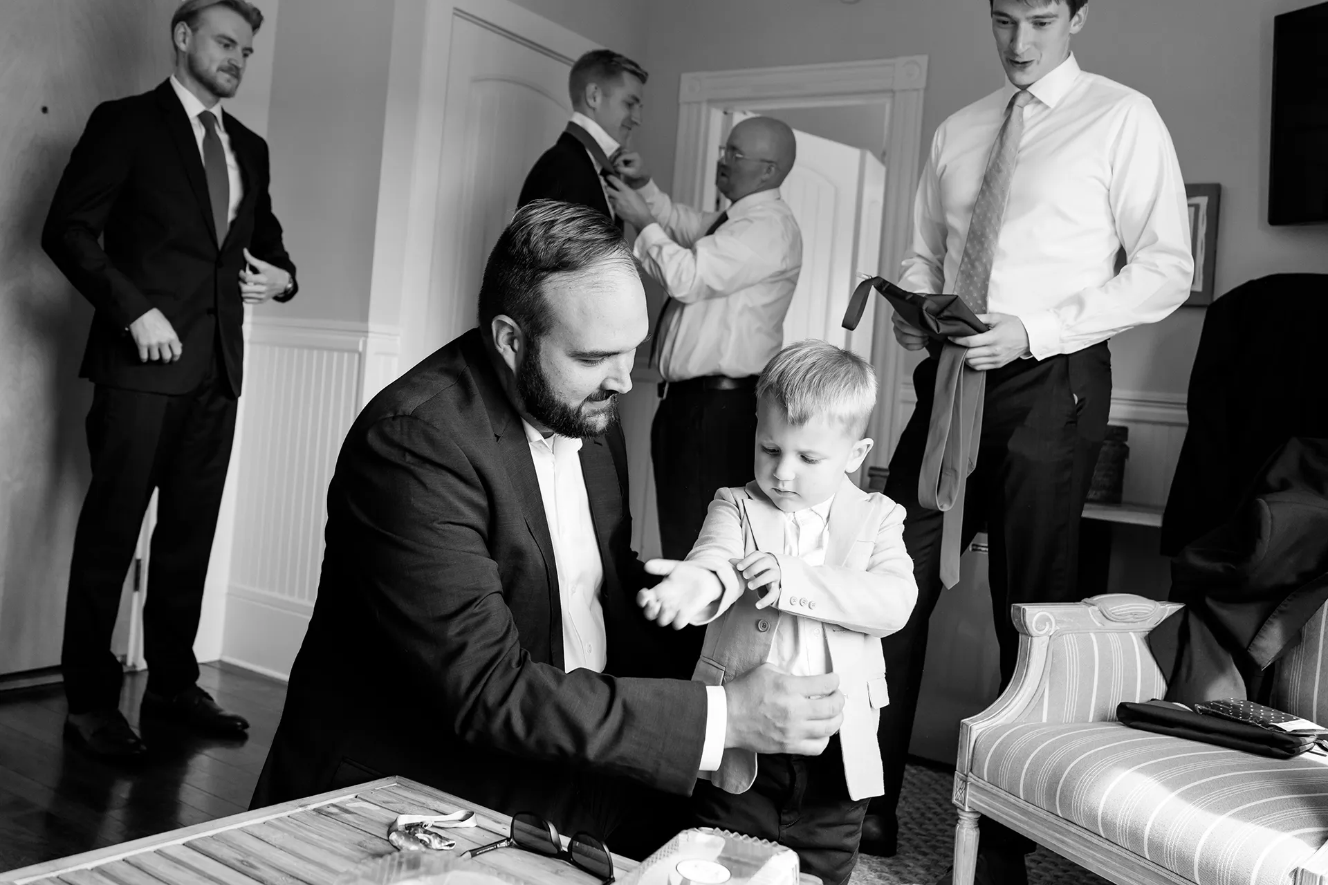 A ring bearer his helped by his dad get ready for a wedding at the Nonantum Resort in Kennebunkport, Maine.