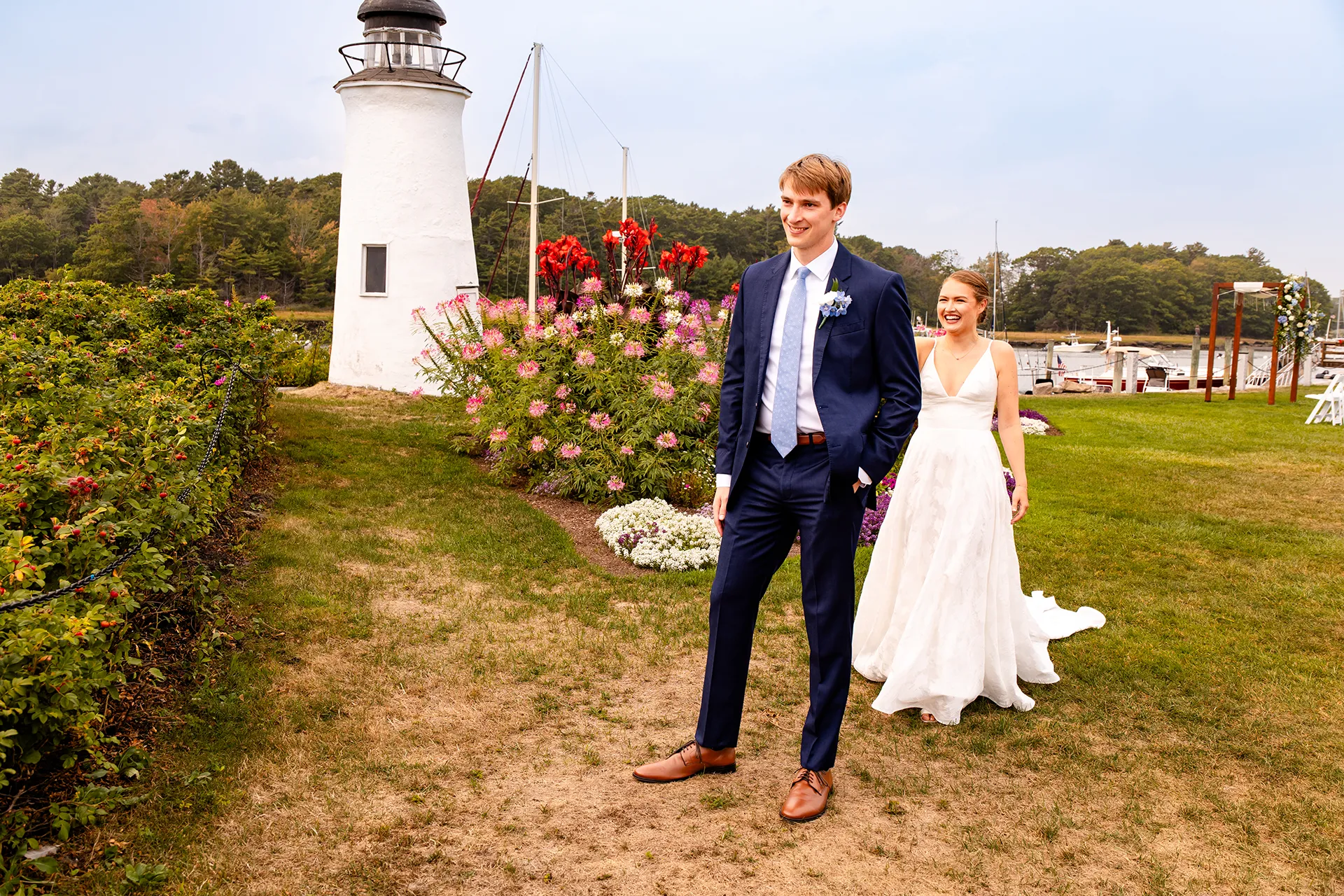 A bride walks up behind a groom during a first look at the Nonantum Resort in Kennebunkport, Maine.
