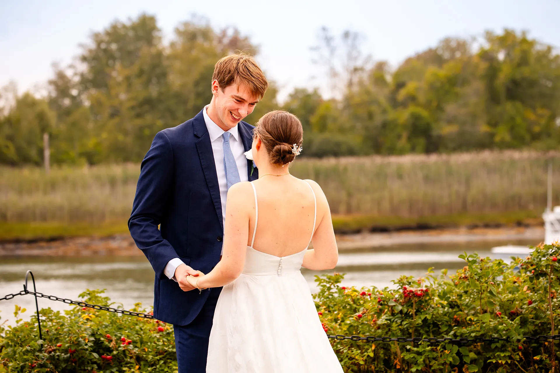 A groom smiles as he sees a bride for the first time during a first look at the Nonantum Resort in Kennebunkport, Maine.