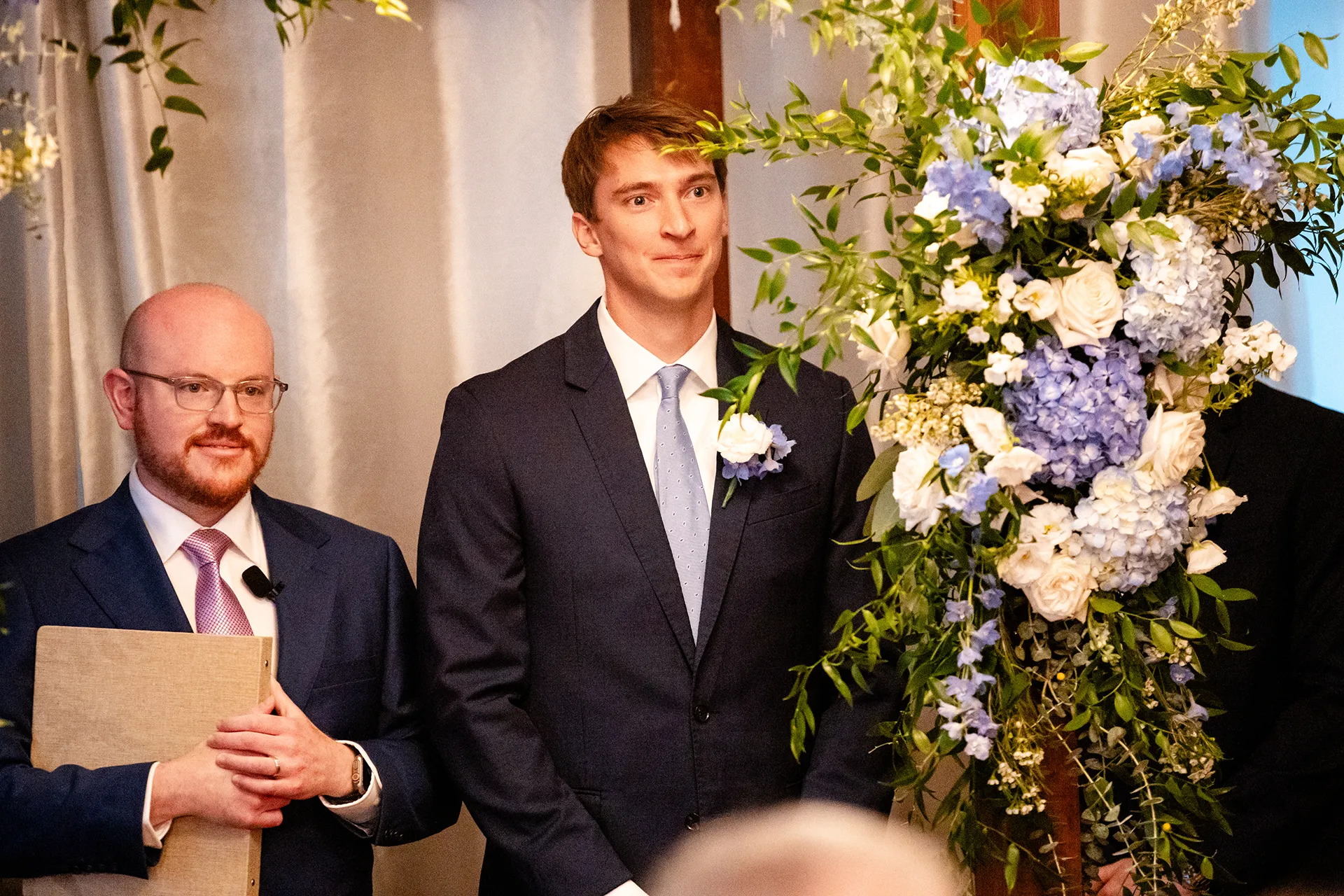 A groom smile as he watches a bride walk down the aisle during a wedding ceremony at the Nonantum Resort in Kennebunkport, Maine.