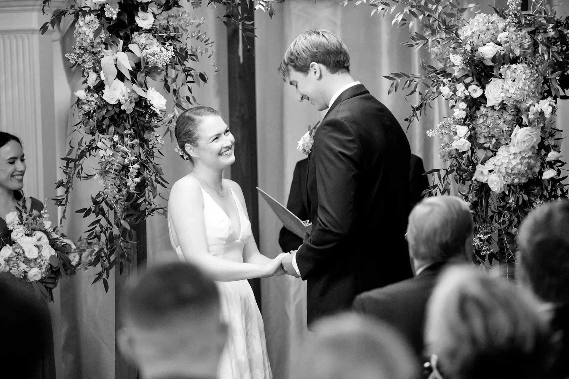 A bride smiles at a groom during a wedding ceremony at the Nonantum Resort in Kennebunkport, Maine.