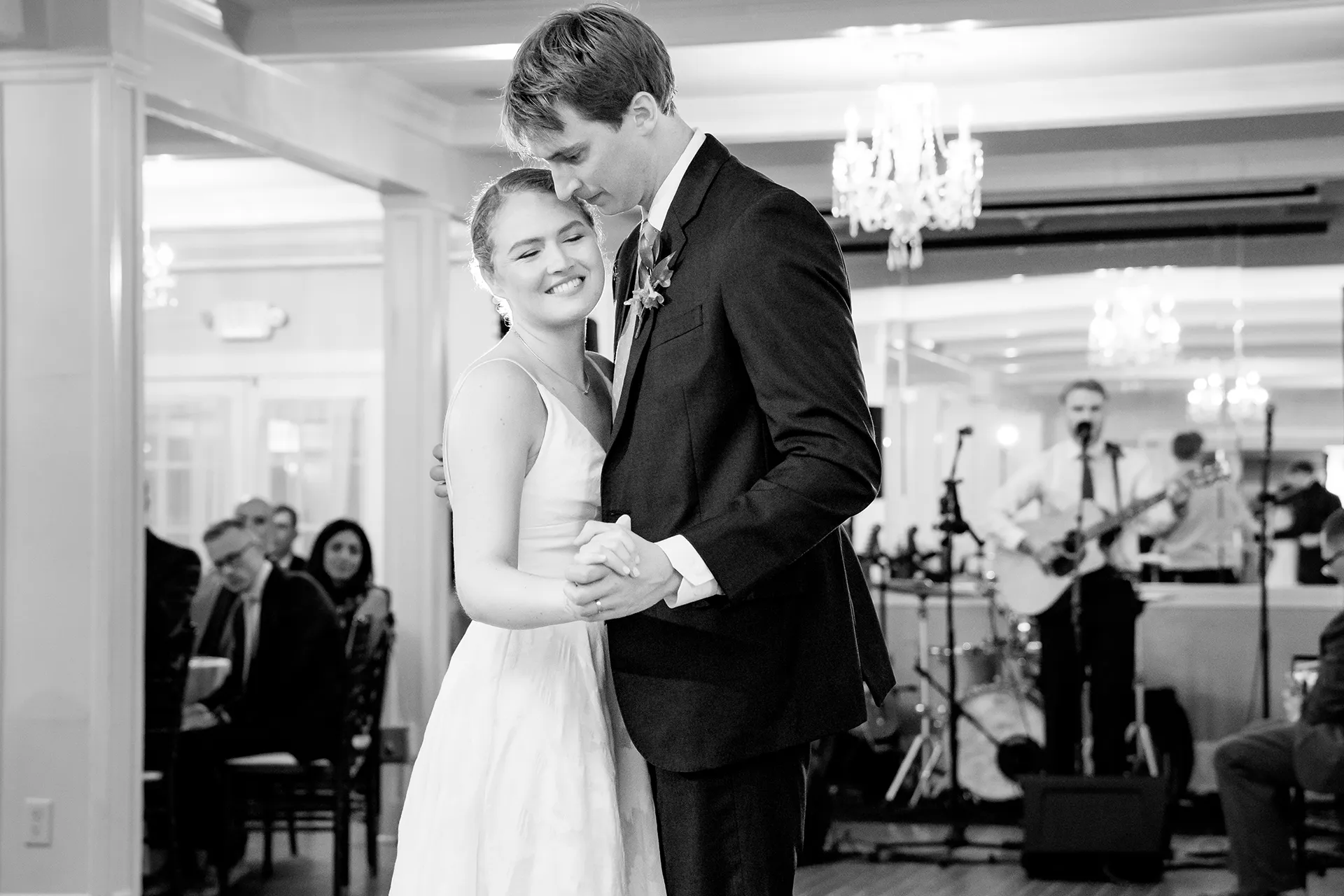 A bride smiles as she dances with a groom during a wedding reception at the Nonantum Resort in Kennebunkport, Maine.