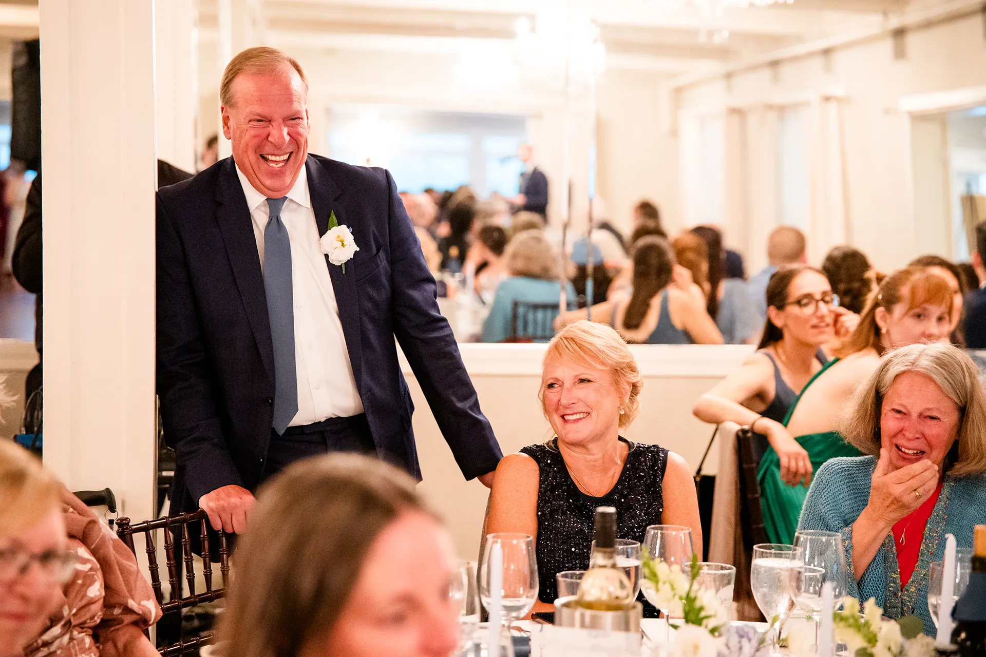 Guests laugh as they listen to a toast during a wedding reception at the Nonantum Resort in Kennebunkport, Maine.
