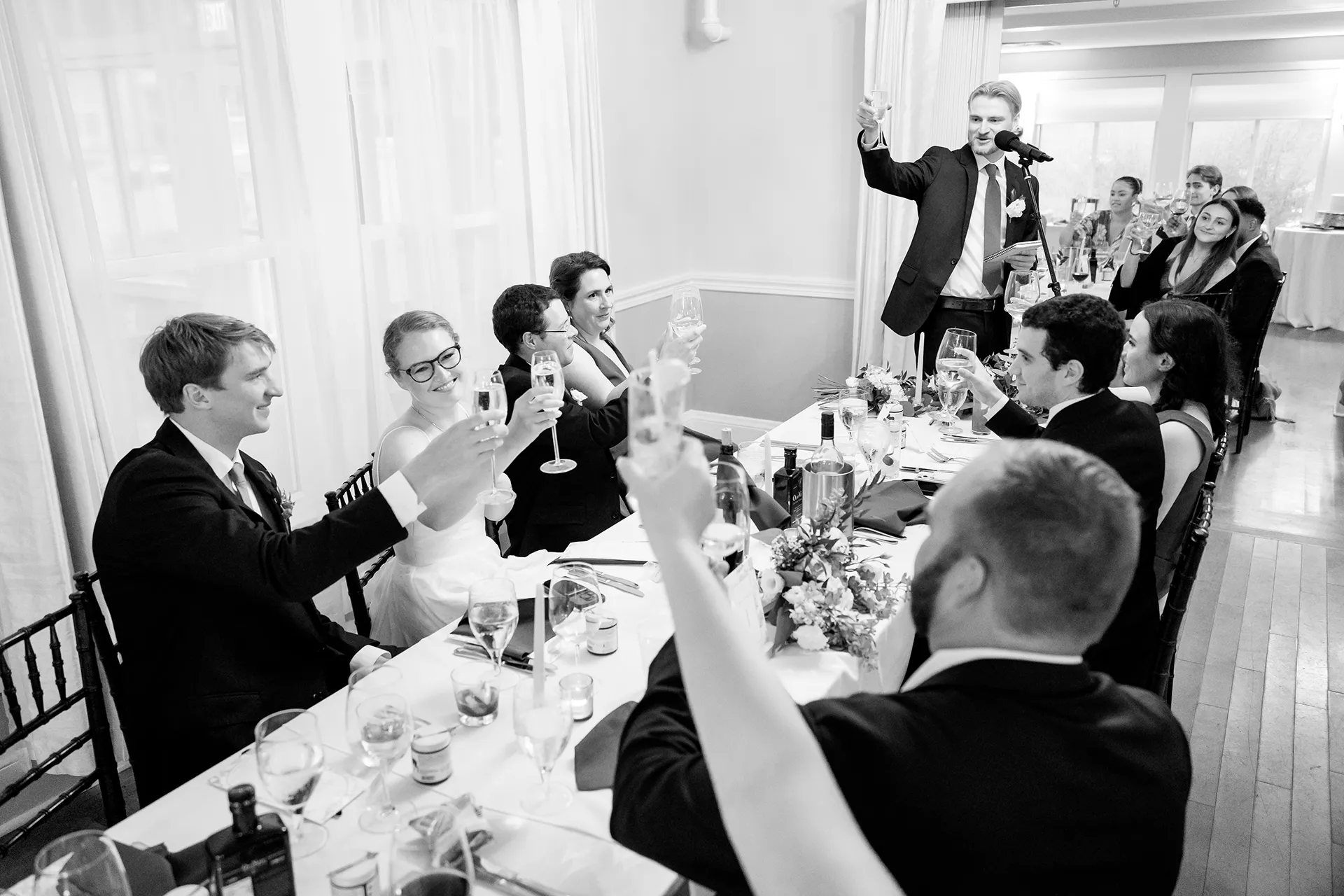 A groomsman toasts a bride and groom during a wedding reception at the Nonantum Resort in Kennebunkport, Maine.