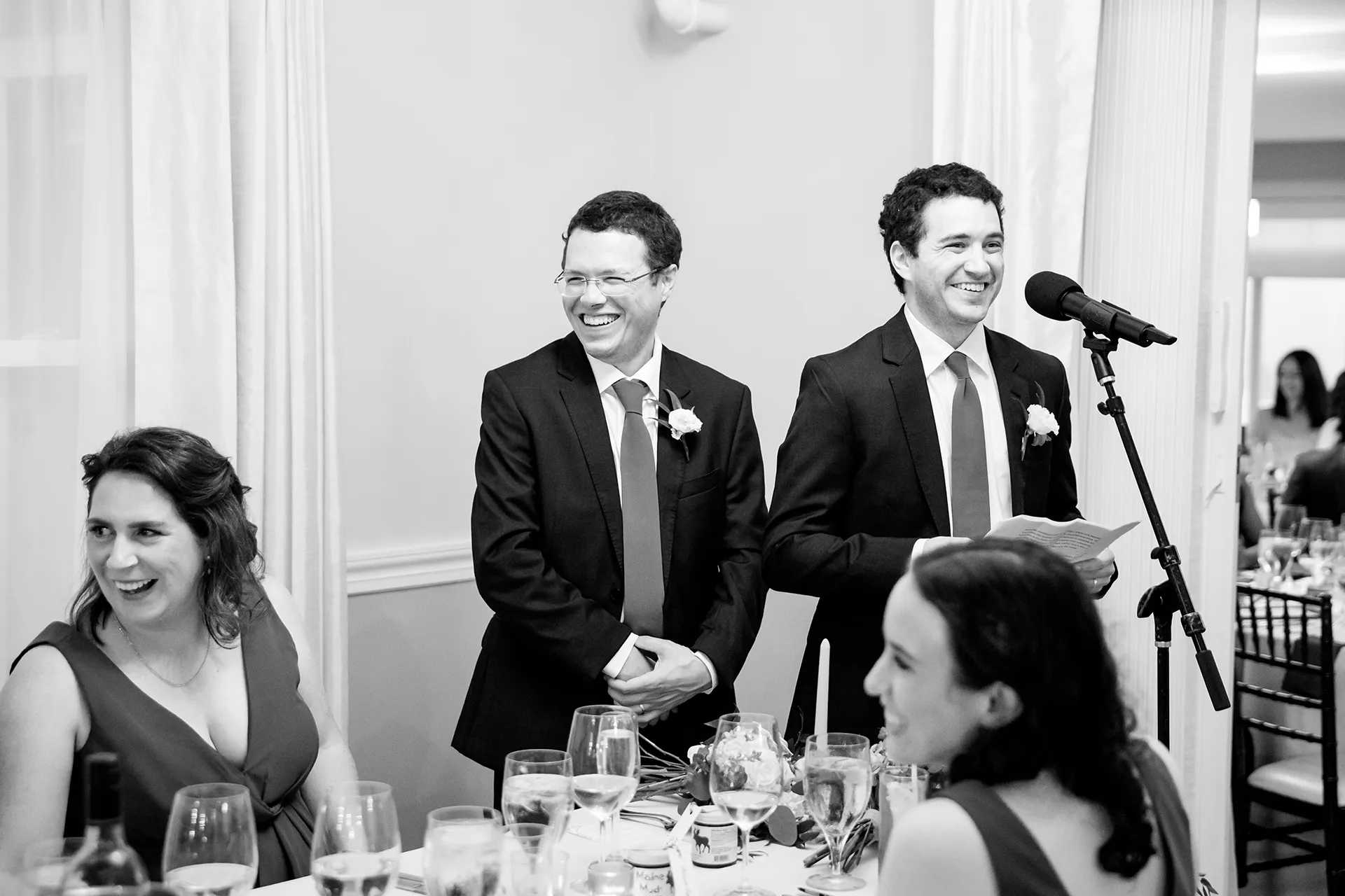 Groomsmen laugh as they give a toast during a wedding reception at the Nonantum Resort in Kennebunkport, Maine.