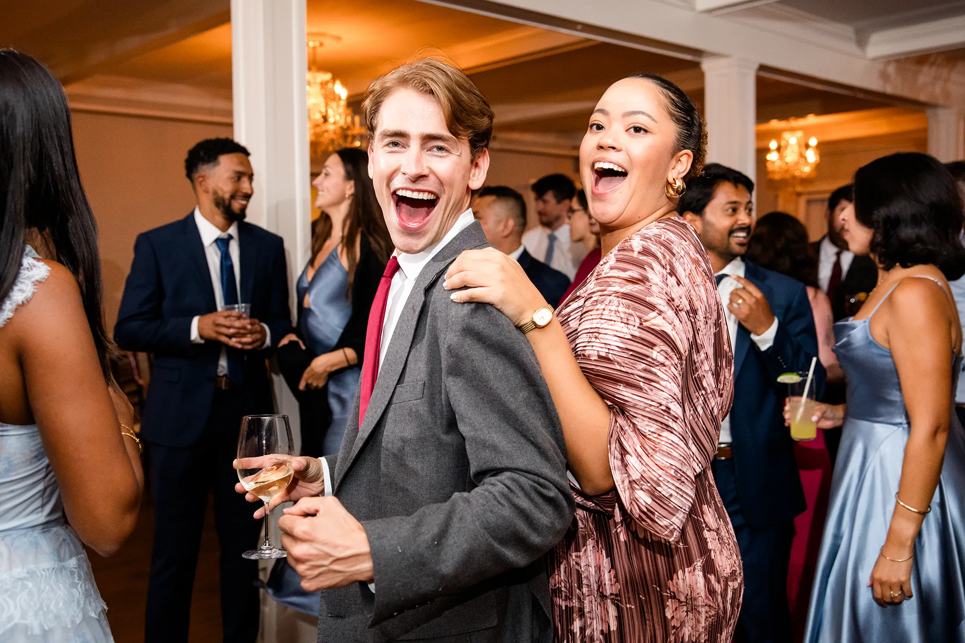 A man and woman laugh as they dance during a wedding reception at the Nonantum Resort in Kennebunkport, Maine.